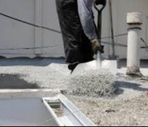 Spreading Gravel on Roof Top Henrico Roofing VA