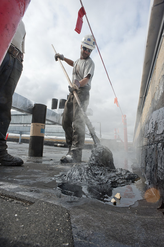 Spreading Hot Tar on a Roof with a Mop